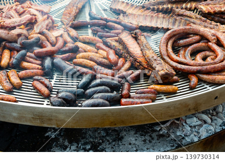 Sausages and ribs grilling on bbq 139730314