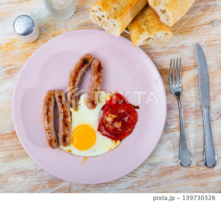 Healthy breakfast of scrambled eggs with sausages 139730326