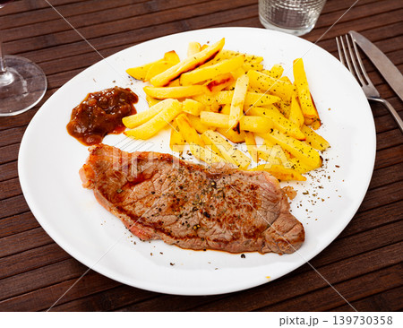 Tasty grilled beef tenderloin with french fries served Tasty grilled beef tenderloin with french fries served 139730358