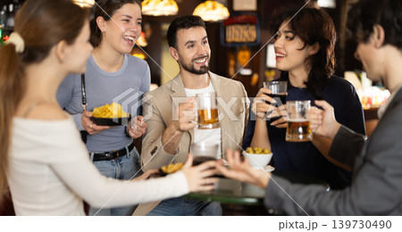 Group of friends happily having time at bar Group of friends happily having time at bar 139730490