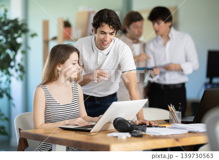 Guy helps girl complete task on laptop Guy helps girl complete task on laptop 139730563