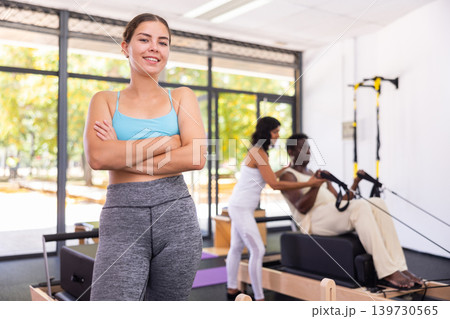 Portrait of girl in sportswear posing in pilates studio. Healthy lifestyle and fitness concept Portrait of girl in sportswear posing in pilates studio. Healthy lifestyle and fitness concept 139730565