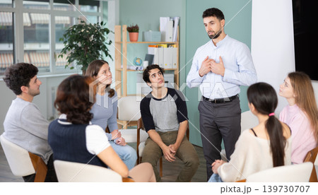 young man speaks to students in a classroom young man speaks to students in a classroom 139730707