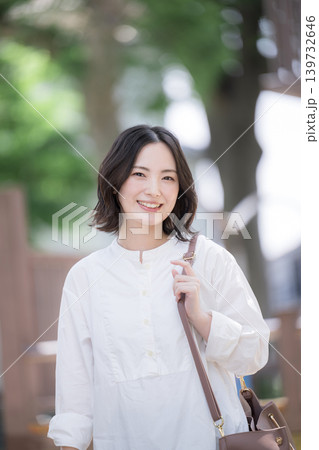 新緑の街を歩く笑顔の女性ナチュラルなライフスタイルイメージ 通勤や爽やかなお出かけなどカメラ目線 新緑の街を歩く笑顔の女性ナチュラルなライフスタイルイメージ 通勤や爽やかなお出かけなどカメラ目線 139732646