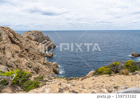 Rocky coastline of Menorca, Spain, with dramatic cliffs and blue sea views on a cloudy day Rocky coastline of Menorca, Spain, with dramatic cliffs and blue sea views on a cloudy day 139733102