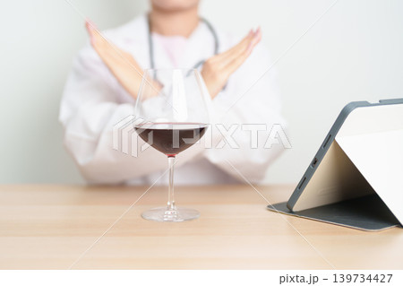 Doctor hand stop to refuse Wine, quitting drink for healthy liver, prevent Alcoholic cirrhosis and cancer, World No Alcohol Day, medical advice for sobriety and Alcoholism and addiction concept Doctor hand stop to refuse Wine, quitting drink for healthy liver, prevent Alcoholic cirrhosis and cancer, World No Alcohol Day, medical advice for sobriety and Alcoholism and addiction concept 139734427