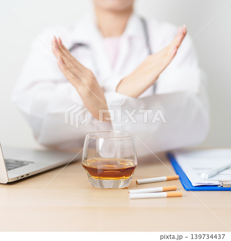 doctor hand making stop sign to refuse whiskey and breaking cigarette, quit smoking and drinking for healthy liver and lung, World No Tobacco and No Alcohol Day and stop alcohol addiction concept doctor hand making stop sign to refuse whiskey and breaking cigarette, quit smoking and drinking for healthy liver and lung, World No Tobacco and No Alcohol Day and stop alcohol addiction concept 139734437