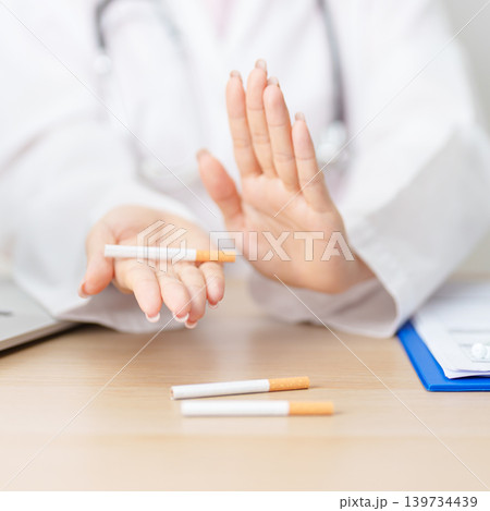 doctor hand making stop sign to refuse and breaking cigarette, quitting smoking for healthy lungs, prevent Lung Cancer and Emphysema, World No Tobacco Day concept 139734439
