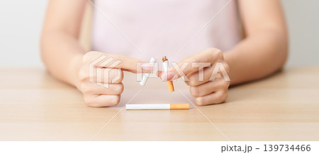woman hand break cigarette for World No Tobacco Day concept, quitting smoking to prevent Lung Cancer, COPD, Emphysema and Tuberculosis disease. healthy lifestyle resolution, stop nicotine addiction woman hand break cigarette for World No Tobacco Day concept, quitting smoking to prevent Lung Cancer, COPD, Emphysema and Tuberculosis disease. healthy lifestyle resolution, stop nicotine addiction 139734466