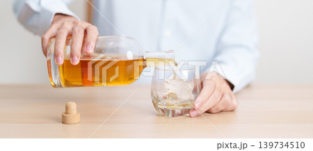 man pour whiskey into a glass on table, suffering from alcohol addiction, alcoholism concept. depicting emotional distress, depression, substance abuse problem, unhealthy lifestyle and mental health man pour whiskey into a glass on table, suffering from alcohol addiction, alcoholism concept. depicting emotional distress, depression, substance abuse problem, unhealthy lifestyle and mental health 139734510