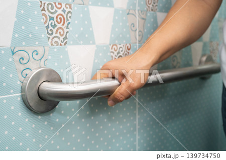 Asian elderly woman use toilet bathroom handle security, healthy strong medical. Asian elderly woman use toilet bathroom handle security, healthy strong medical. 139734750