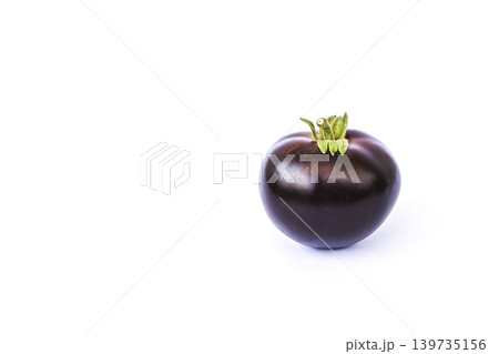 A single ripe purple Indigo Rose heirloom tomato isolated on  white background. 139735156