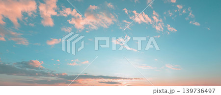 Soft clouds drift across a serene blue sky 139736497
