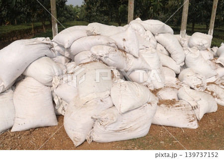 pile of white sacks with fertilizer on farm 139737152