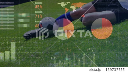 Sliding soccer player wearing blue socks, shin guard on grass pitch, showing data overlay and ball Sliding soccer player wearing blue socks, shin guard on grass pitch, showing data overlay and ball 139737755
