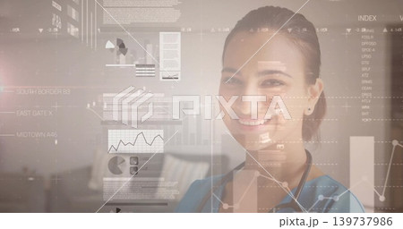 Smiling medical clinician in blue scrubs with stethoscope viewing HUD charts in clinic, copy space Smiling medical clinician in blue scrubs with stethoscope viewing HUD charts in clinic, copy space 139737986