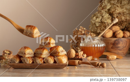 Baklava with walnuts and honey on a beige background. 139738097