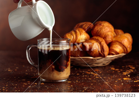 Coffee latte and croissants on a brown background. Coffee latte and croissants on a brown background. 139738123