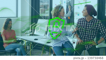 Talking woman with glasses in blue shirt leading meeting at open office with writable glass wall Talking woman with glasses in blue shirt leading meeting at open office with writable glass wall 139738468