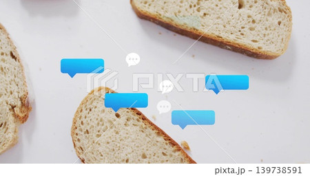 Displaying whole-grain bread slices and crumbs on white tabletop with blue and white speech bubbles Displaying whole-grain bread slices and crumbs on white tabletop with blue and white speech bubbles 139738591