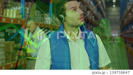 Inspecting man in blue vest and headset checking warehouse shelving with scanner and data overlays Inspecting man in blue vest and headset checking warehouse shelving with scanner and data overlays 139738647