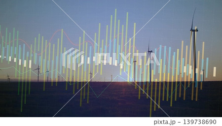 Displaying row of modern wind turbines standing silhouetted in field at sunset, with data overlay 139738690
