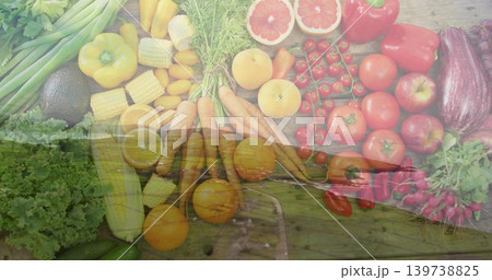 Displaying fresh produce carrots tomatoes corn avocado on rustic wood overlaying marsh boardwalk 139738825