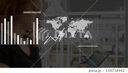 Holding woman in dark V-neck viewing tablet in office, with world map and graphs, copy space 139738942