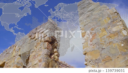 Displaying weathered sandstone pillars and arched opening at ancient ruin site, with map overlay Displaying weathered sandstone pillars and arched opening at ancient ruin site, with map overlay 139739031