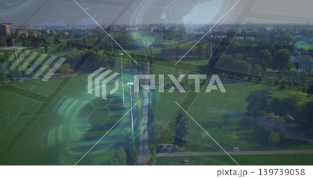 Stretching central tree-lined walkway through urban park, showing lamp posts, benches, pond and HUD 139739058