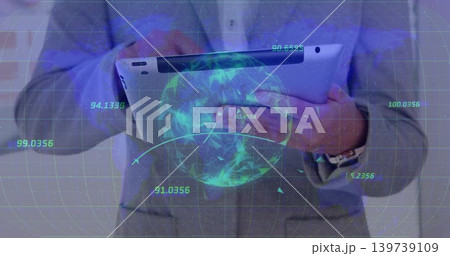 Presenter in gray suit jacket holding tablet in office, showing holographic globe, HUD, wristwatch 139739109
