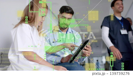 Showing clinician in shirt and stethoscope pointing tablet in clinic corridor, HUD overlay 139739276