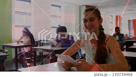 Smiling teen girl white tank top holding tablet at classroom windows, red data overlay, copy space 139739466