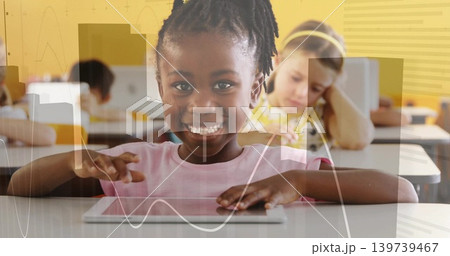 Smiling African American student using tablet at elementary classroom, wearing pink shirt, graphs Smiling African American student using tablet at elementary classroom, wearing pink shirt, graphs 139739467