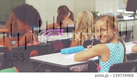 Smiling blonde girl in turquoise dress at school desk holding pencil, blue box overlay, copy space Smiling blonde girl in turquoise dress at school desk holding pencil, blue box overlay, copy space 139739468
