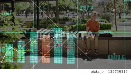 Orange-hoodie man checking phone on concrete ledge in park, bike and bag, data-overlay, copy space 139739513