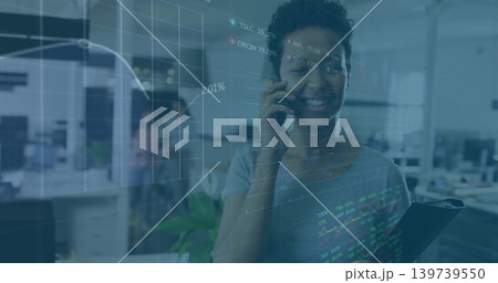 Talking woman in short-sleeve top holding clipboard and smartphone in office with charts overlay 139739550