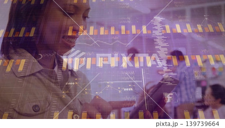 Analyzing woman in light collared jacket tapping tablet in office meeting with bar charts Analyzing woman in light collared jacket tapping tablet in office meeting with bar charts 139739664