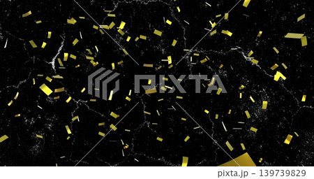 Floating gold confetti and foil pieces shining over black marble, folded gold foil lower-right Floating gold confetti and foil pieces shining over black marble, folded gold foil lower-right 139739829