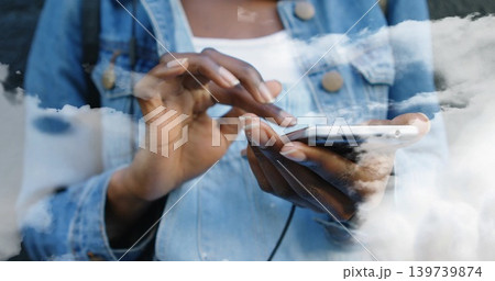 Tapping woman wearing denim jacket and white top at window, phone and earphone cable showing, nails Tapping woman wearing denim jacket and white top at window, phone and earphone cable showing, nails 139739874