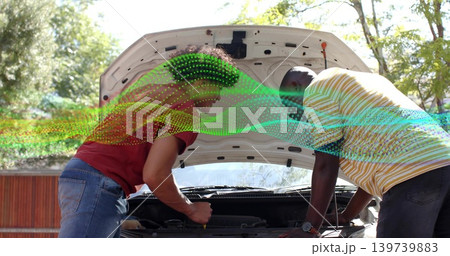 Leaning two men in red tee, striped polo inspecting engine in driveway, tool, digital wave overlay 139739883