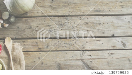 Showing kitchen scene with wooden spoons on burlap, garlic, olives, gourd, pepper, copy space 139739926