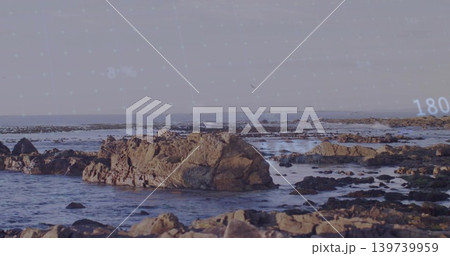 Showing large jagged rock rising from shallow surf at rocky coast, with digital overlay 180 Showing large jagged rock rising from shallow surf at rocky coast, with digital overlay 180 139739959