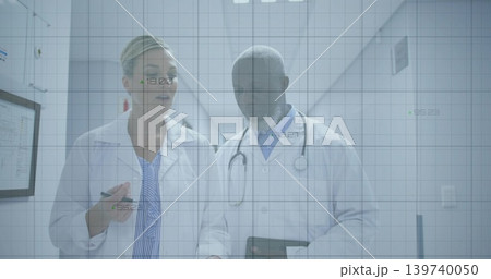 Walking doctors in labcoats using tablet in clinic hall, woman pointing pen, stethoscope, data grid Walking doctors in labcoats using tablet in clinic hall, woman pointing pen, stethoscope, data grid 139740050
