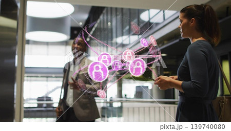 Viewing duo wearing suit and dress interacting with AR network in lobby, holding smartphone and bag 139740080