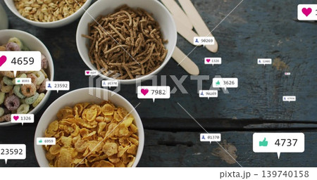 Showing four white cereal bowls on worn blue table with wooden spoons, reaction bubbles, copy space 139740158