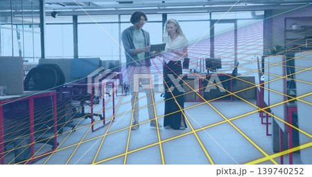Reviewing two coworkers in work clothes examining tablet in open office, with wireframe grid Reviewing two coworkers in work clothes examining tablet in open office, with wireframe grid 139740252