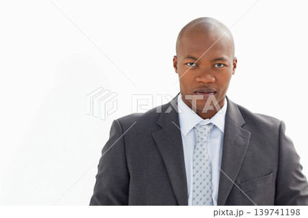 African American man late 20s wearing suit jacket and patterned tie, posing in studio, copy space African American man late 20s wearing suit jacket and patterned tie, posing in studio, copy space 139741198