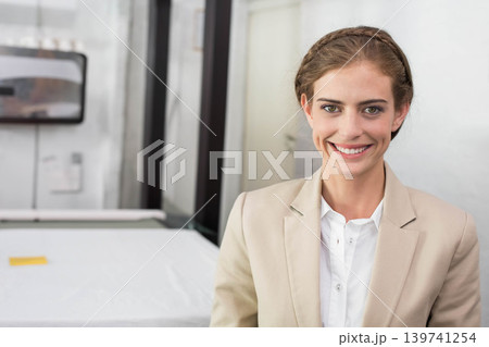 Female in beige blazer smiling while standing at mattress showroom with note, copy space Female in beige blazer smiling while standing at mattress showroom with note, copy space 139741254