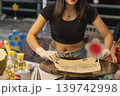 In a busy Bangkok street stall, a woman cooks a sweet roti pancake. She skillfully spreads the dough while customers watch and wait for their tasty treat. High quality photo 139742998